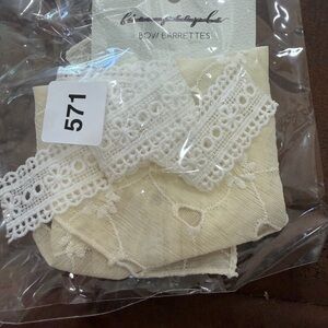 Free People bow barrette featuring delicate cream lace and embroidery detailing
